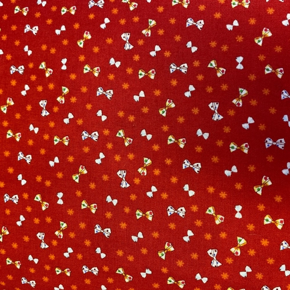 bavlna barevné mašličky na červeném podkladě 110 cm